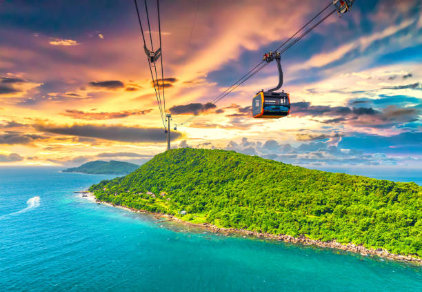 View of longest cable car ride in the world, Phu Quoc island, Vietnam, sunset sky. Below is seascape with tropical islands and boats.