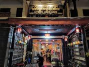 Exterior of Ganesh Hoi An Indian Restaurant at night with warm lights and signage