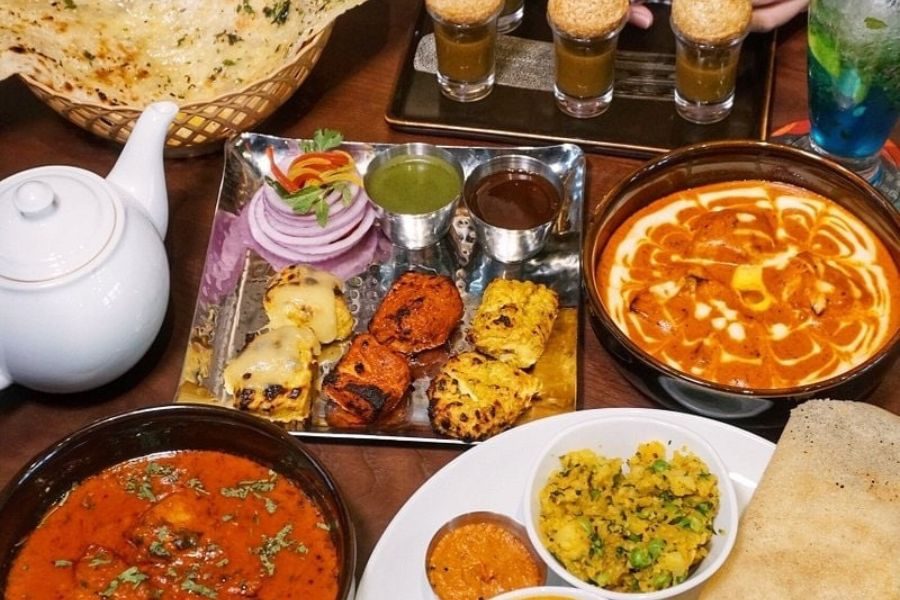 Indian curry set with naan, dal, and tandoori dishes at Maharaja Phu Quoc