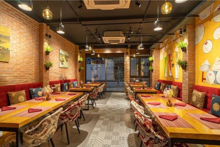 Spacious dining area with warm decor at Makhan Bhog Indian Restaurant
