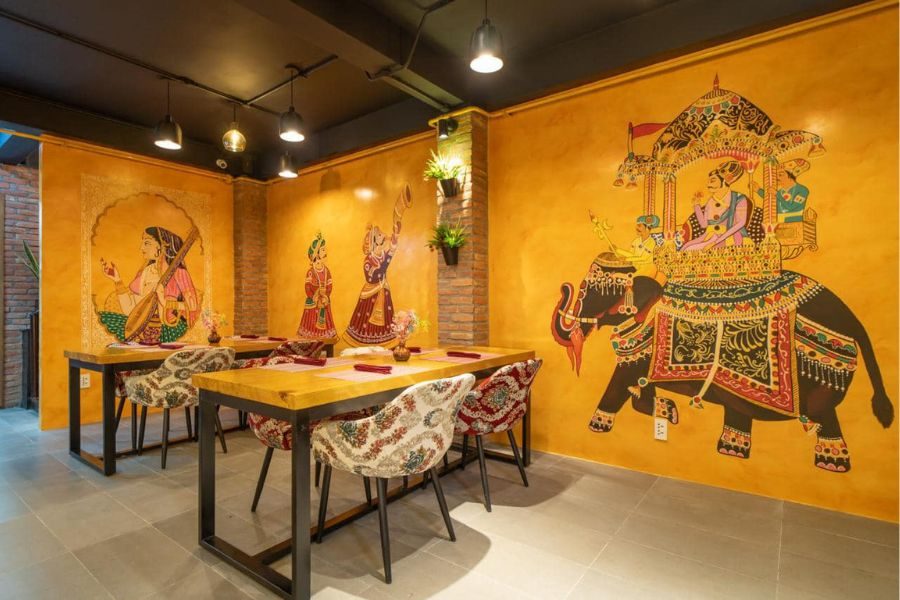 Spacious dining area with warm decor at Makhan Bhog Indian Restaurant
