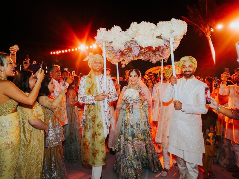 Beautiful pink and white floral Mandap on the white sand beach of Phu Quoc for an Indian wedding ceremony.