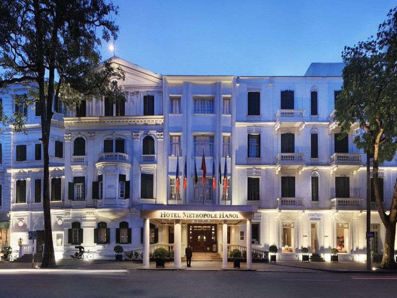 Sofitel Legend Metropole Hanoi illuminated at dusk with classic facade