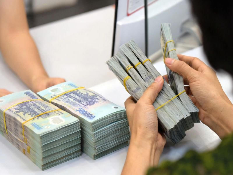 Counting Vietnamese dong cash at a currency exchange counter