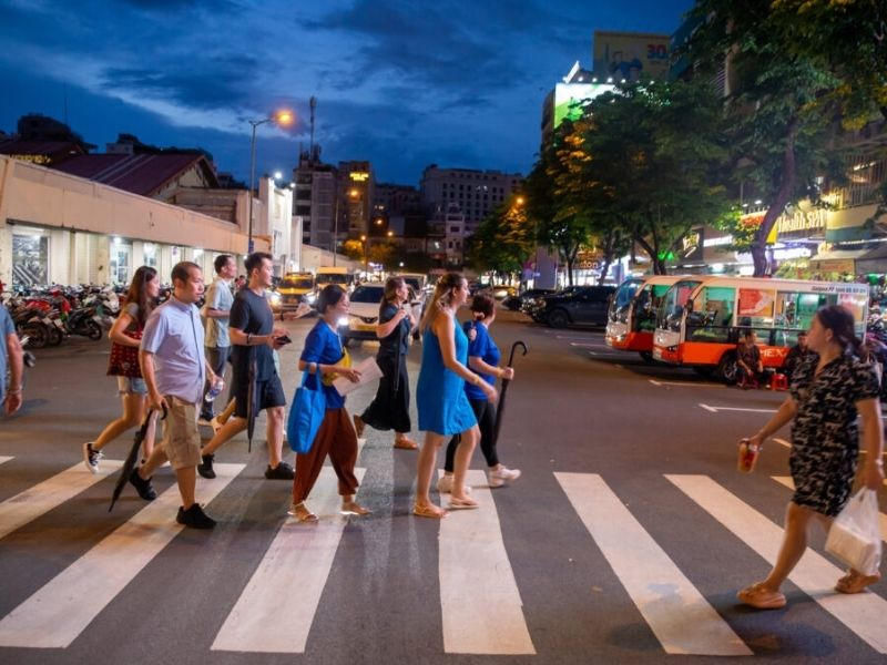 Tourists crossing a busy street in Ho Chi Minh City