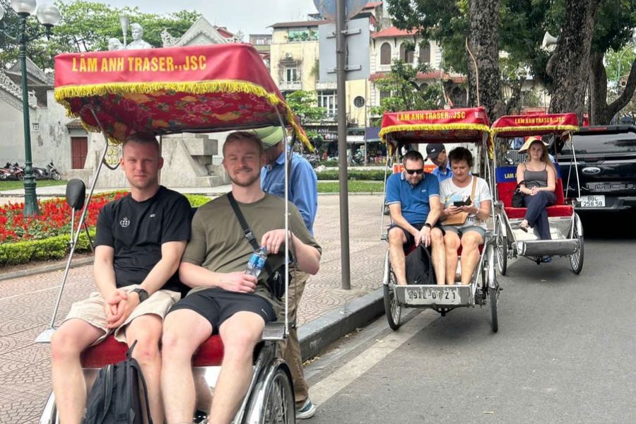 Foreign tourists enjoying a cyclo tour in Hanoi