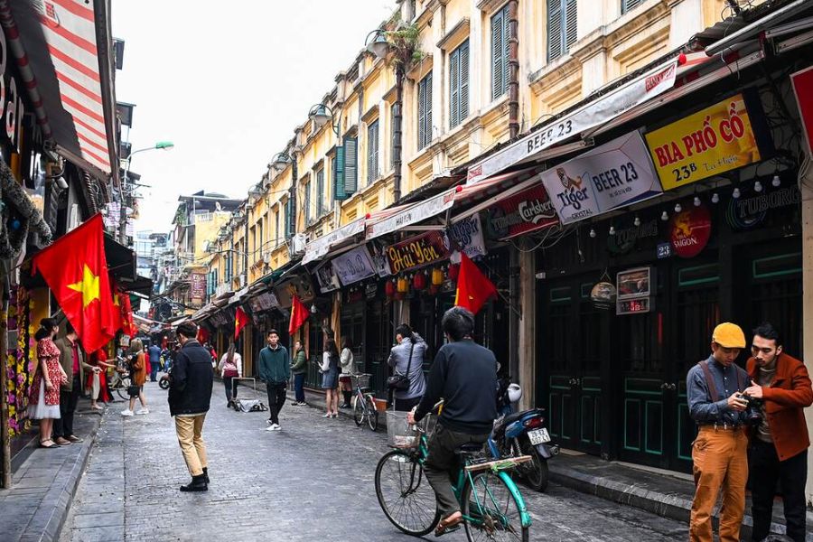 People walking in Hanoi Old Quarter narrow street