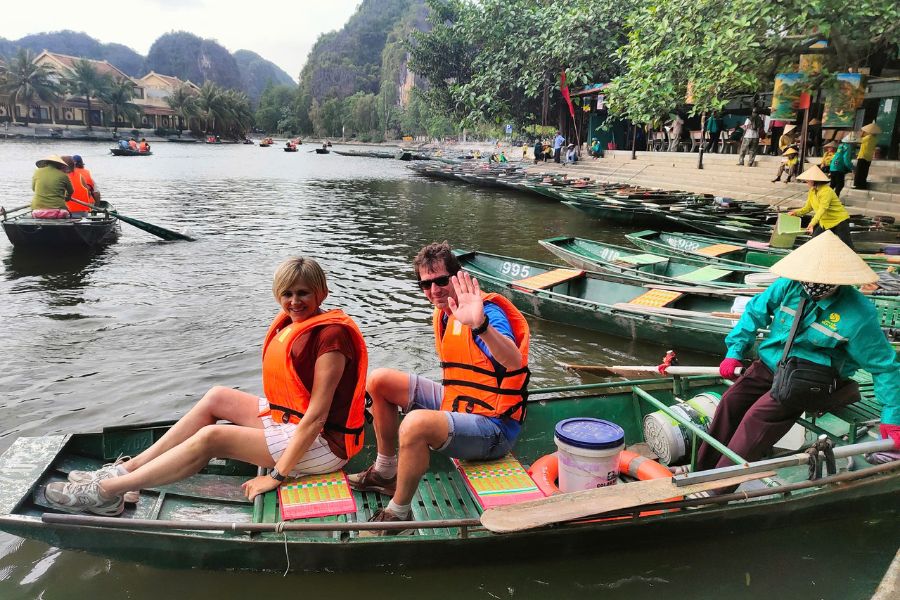 Tourists on a traditional boat trip in Tam Coc