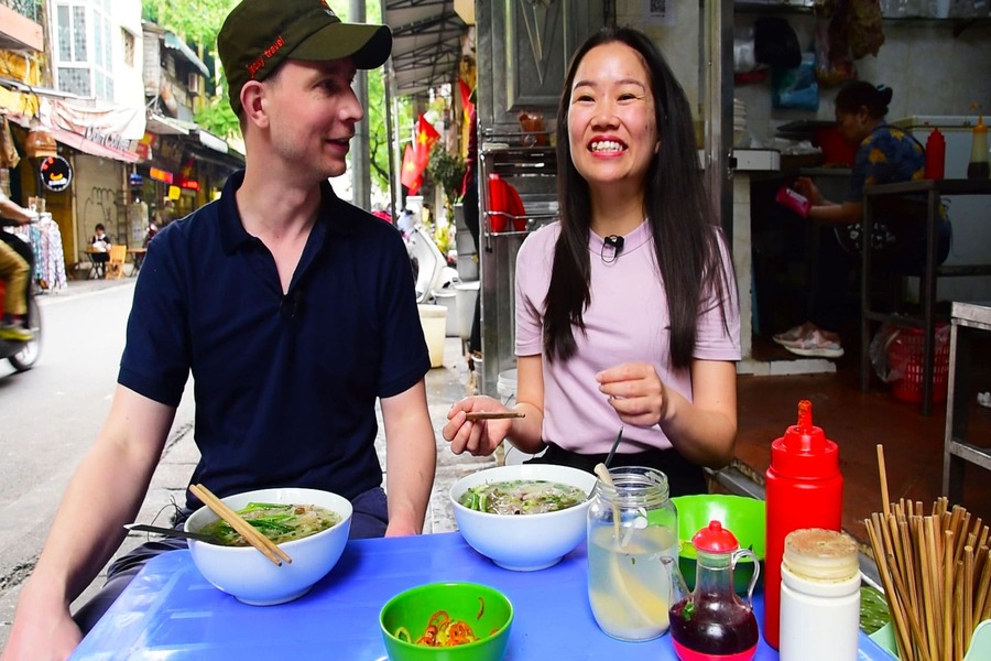 Tourists enjoy Hanoi street foods