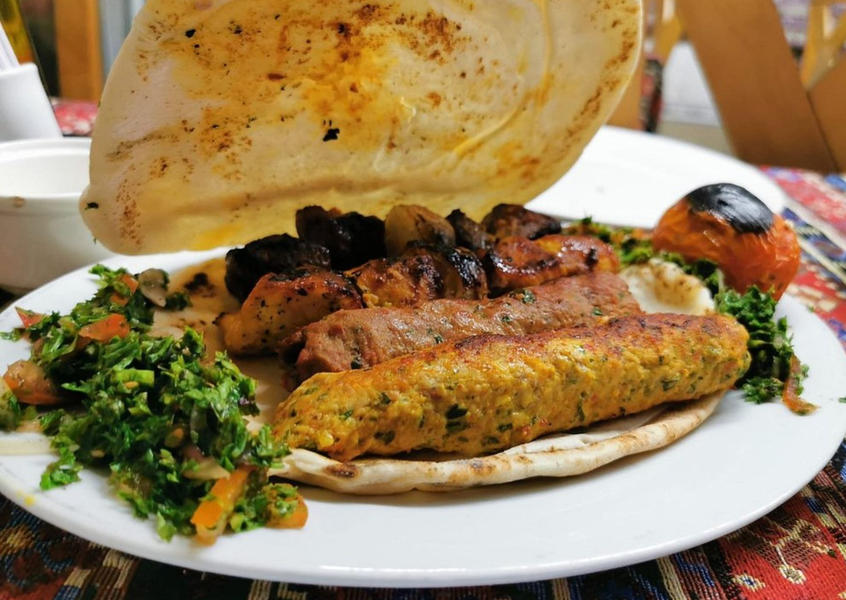 Middle Eastern mixed grill platter with kebab and flatbread
