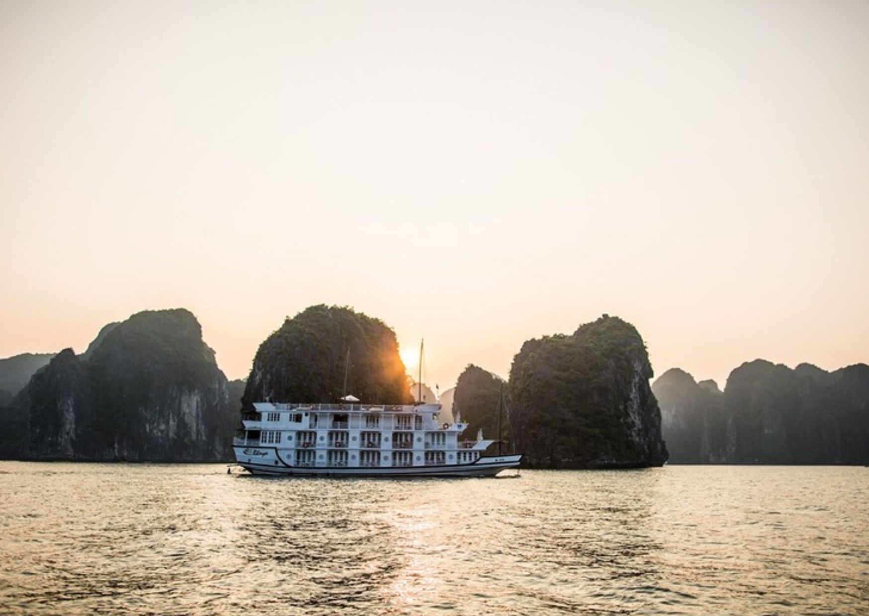 Cruise ship at sunset in Ha Long Bay, Vietnam