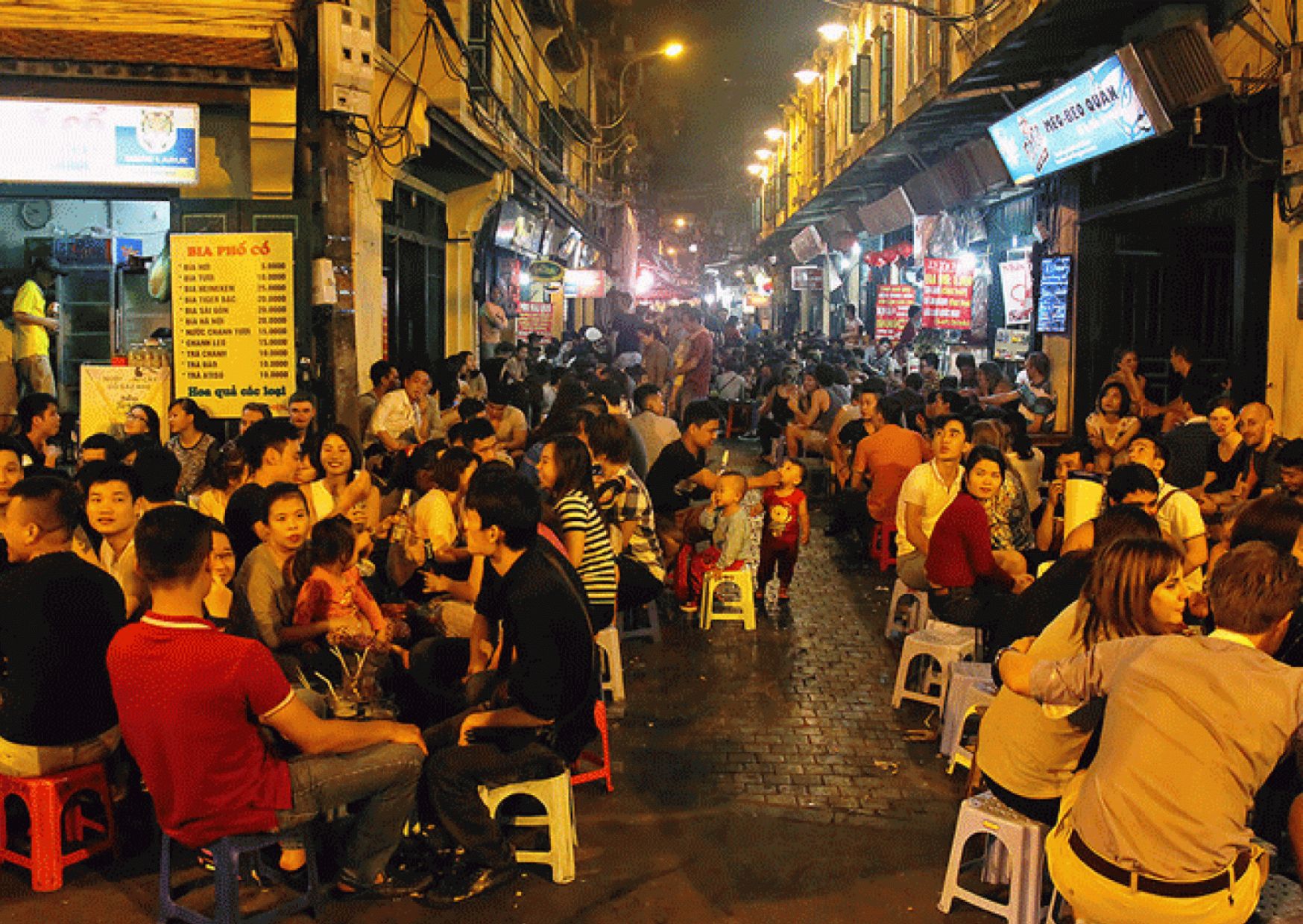 Crowded outdoor seating at Ta Hien Beer Street at night