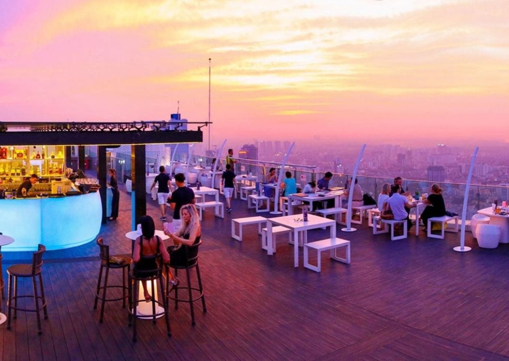 Stylish rooftop lounge with sunset city views