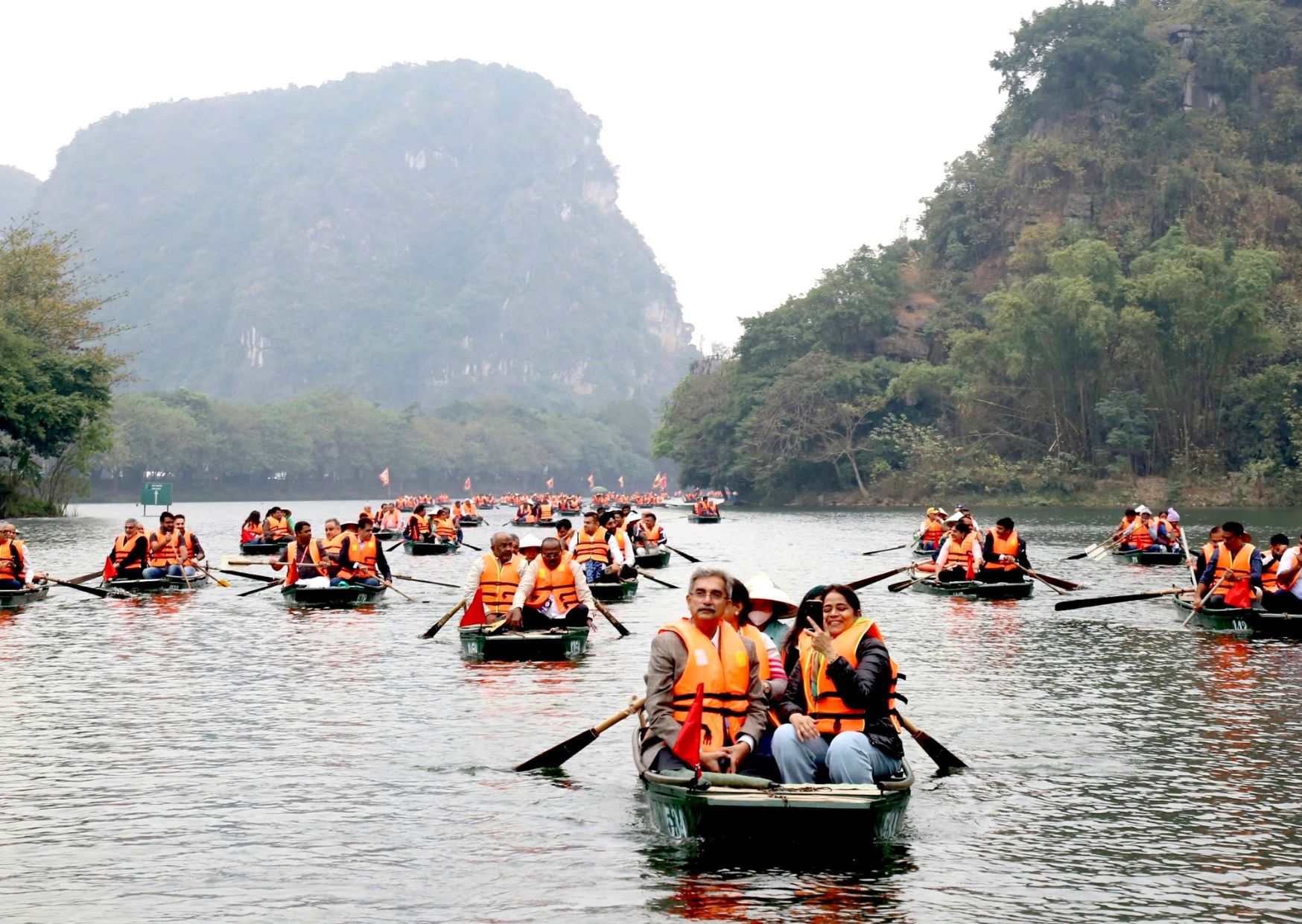 Tourists on rowing boats at Trang An, Ninh Binh