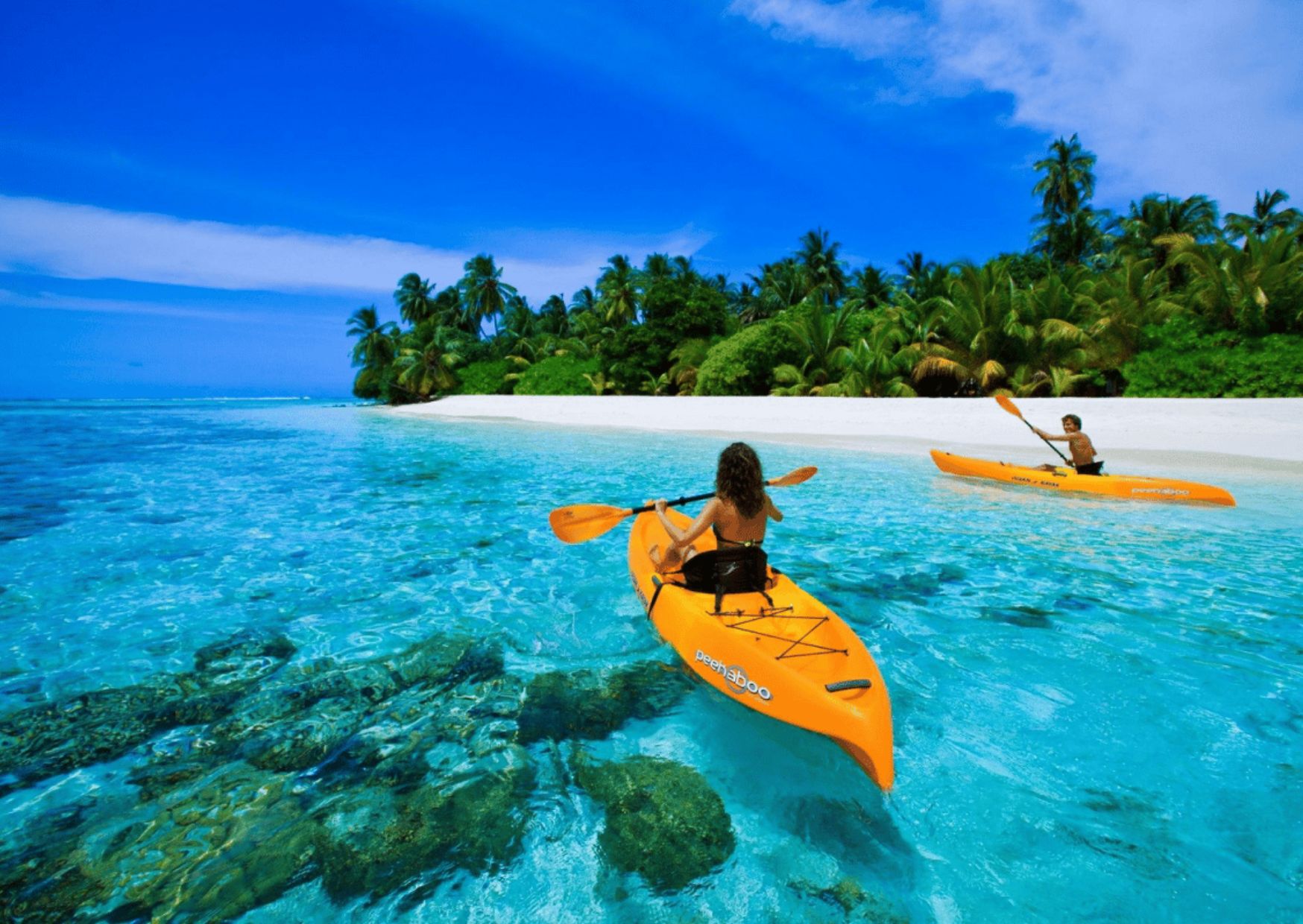 Kayaking in the crystal clear water of a tropical beach