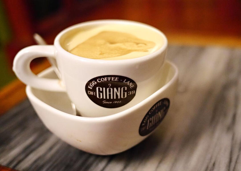 A white cup of traditional Vietnamese egg coffee at Cafe Giang