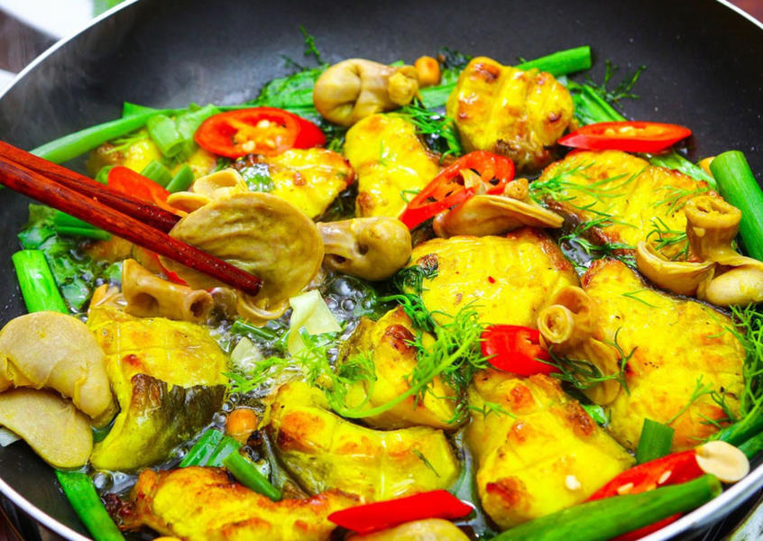 Vietnamese grilled fish with dill cooking in a pan