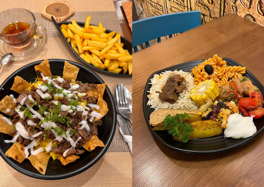 Plates of rice, chicken satay with sauce, and gado-gado