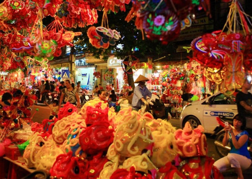 Colorful lanterns and festive decorations filling a night market during Vietnam's Mid-Autumn Festival