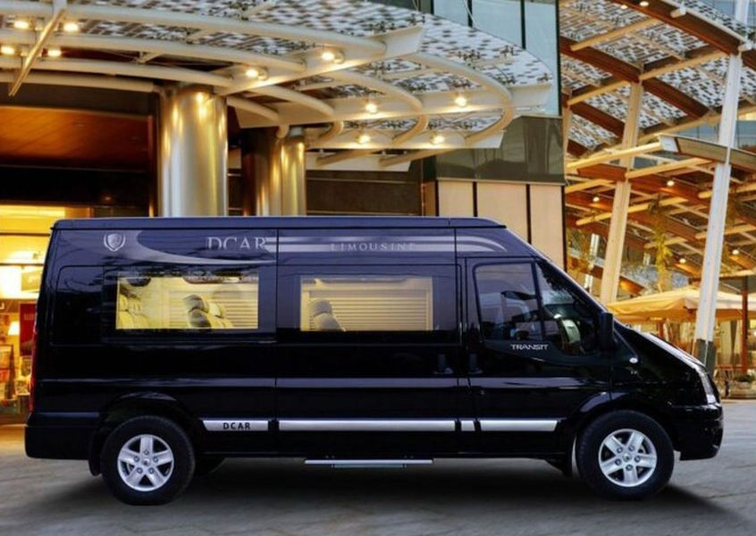 Black DCAR limousine van parked outside a hotel in Vietnam
