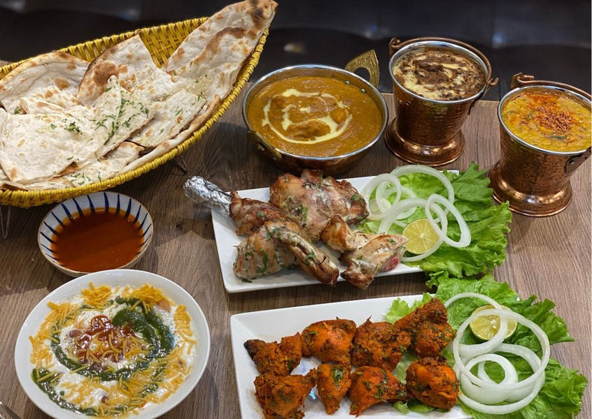 Indian dishes with naan, tandoori chicken, and curry