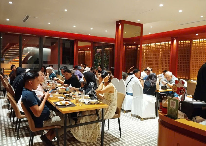 People dining at tables inside a modern cozy restaurant