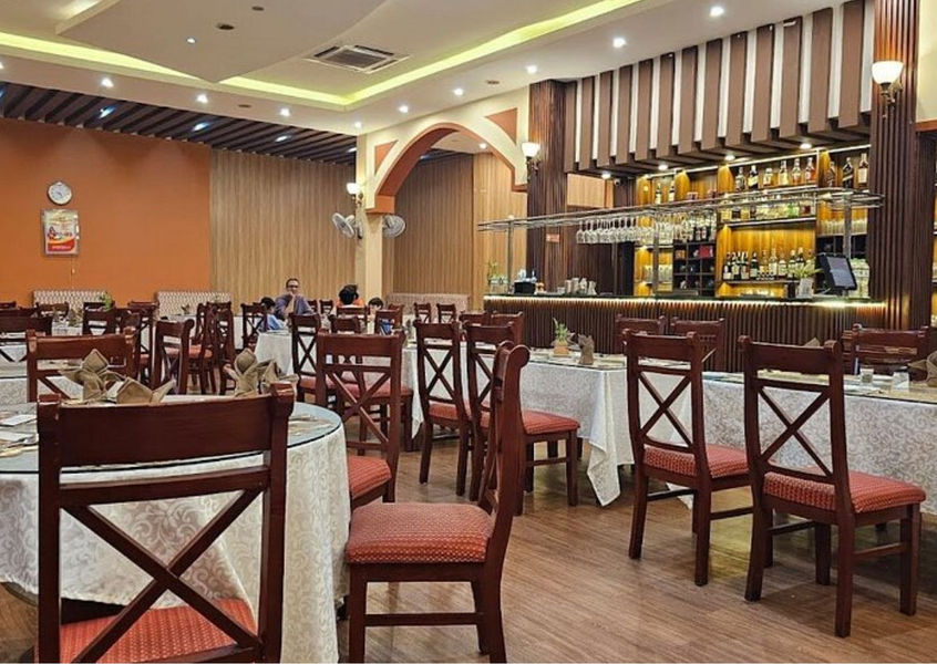 Dining room of a restaurant with a bar counter and tables