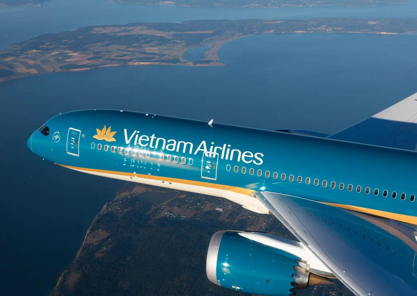 Vietnam Airlines aircraft flying over coastal landscape
