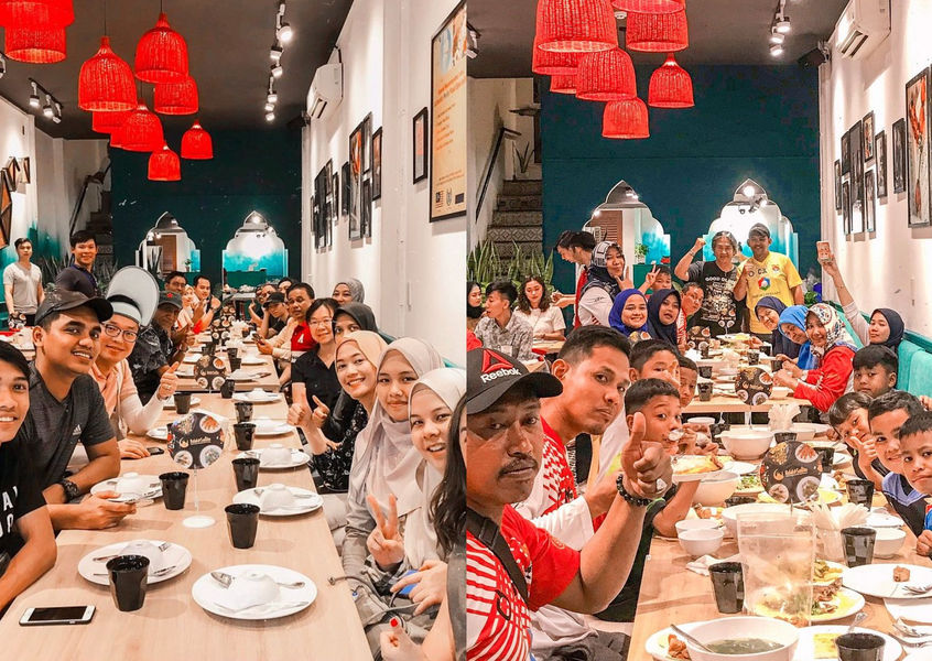 Group of Muslim travelers posing at Halal Saigon restaurant table