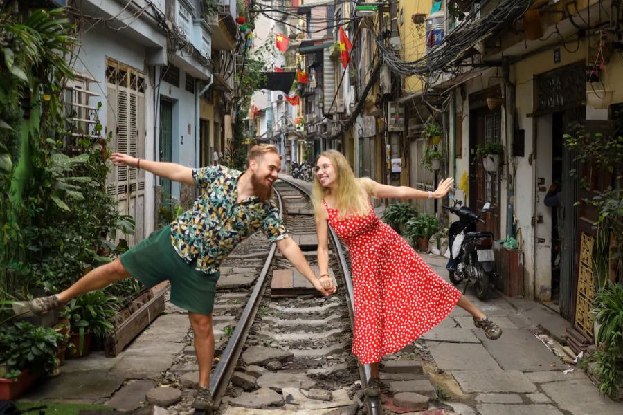 Couple posing on railway tracks in Hanoi Old Quarter