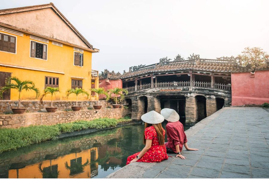 Couple sitting by Japanese Covered Bridge in Hoi An