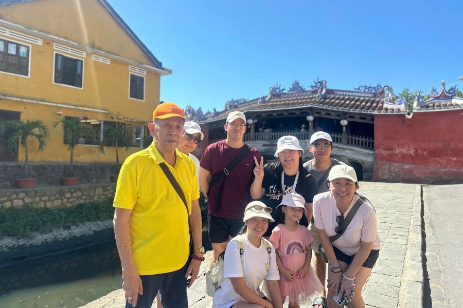 Family gathered near Hoi An's iconic riverside bridge
