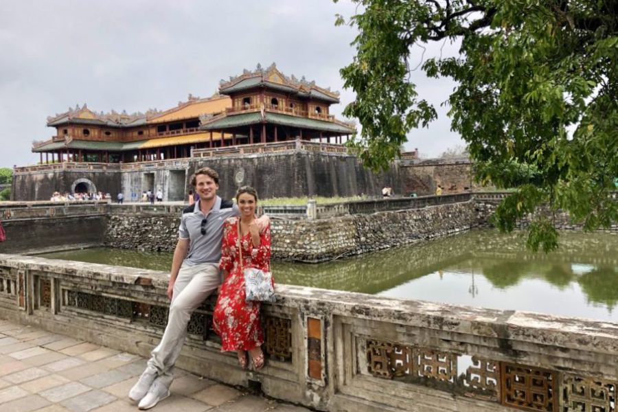 Couple sitting by moat at Hue Imperial Citadel