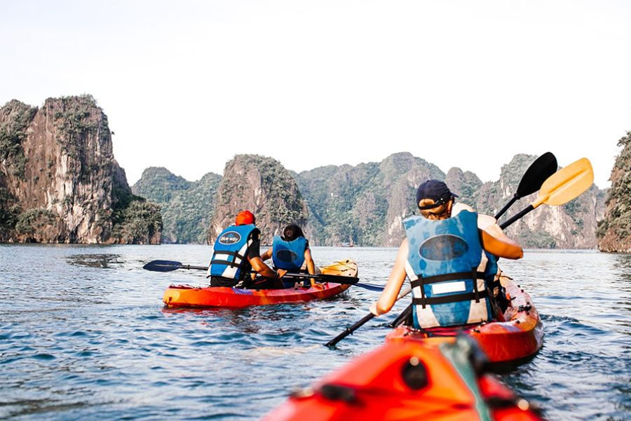 Paddling by kayak through Ha Long Bay's limestone islets