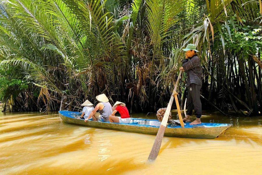 Gliding by sampan through Mekong Delta's palm-lined canals
