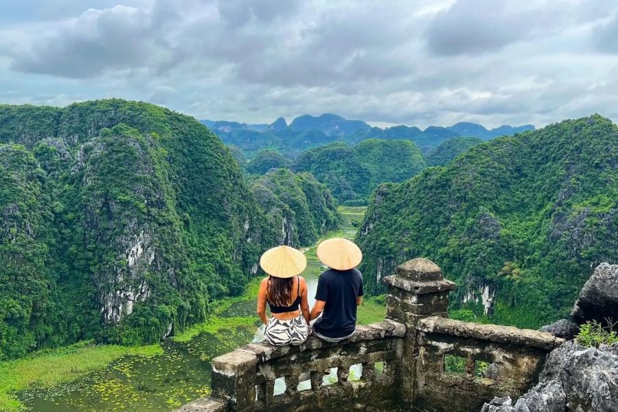 Couple overlooking Ninh Binh limestone karsts and rice fields