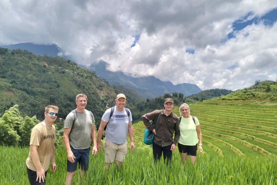 Friends pausing for a photo amid Sapa's green terraces
