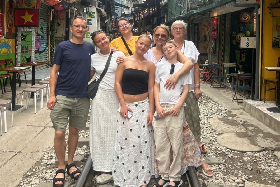 Tourist group standing on Hanoi Train Street tracks