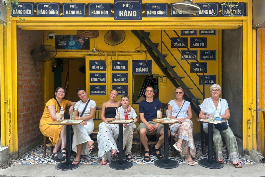 Small group enjoying drinks outside a Hanoi Old Quarter