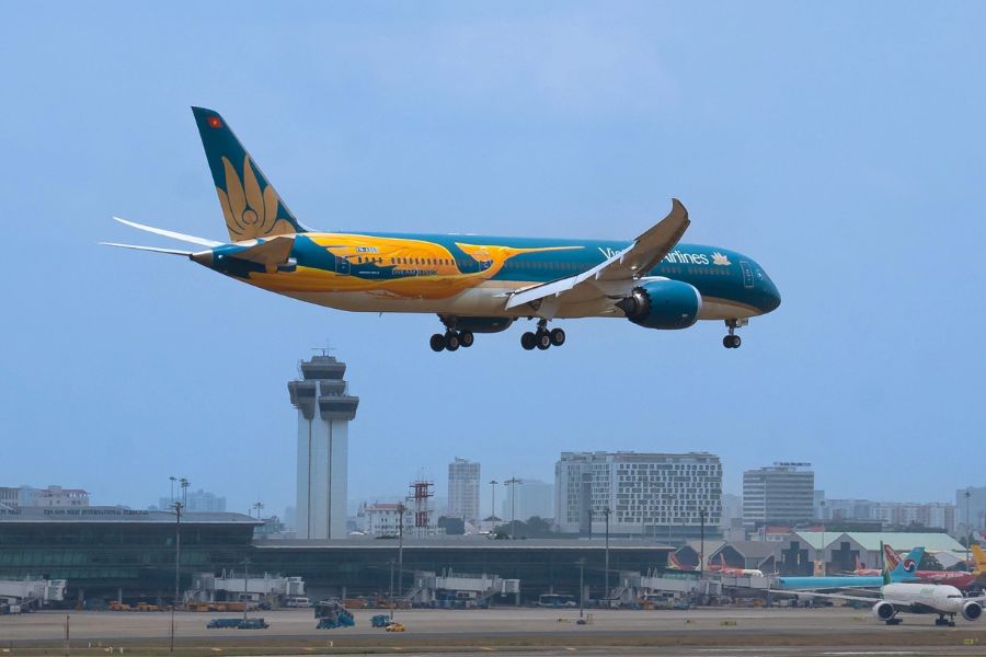 Vietnam Airlines aircraft landing near airport control tower