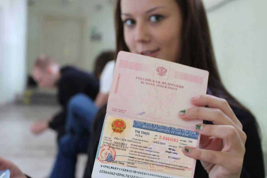 Traveler holding passport with Vietnam single-entry visa sticker