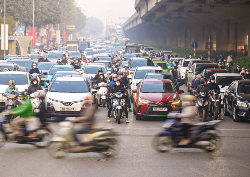 Dense motorbike and car traffic on a Hanoi street