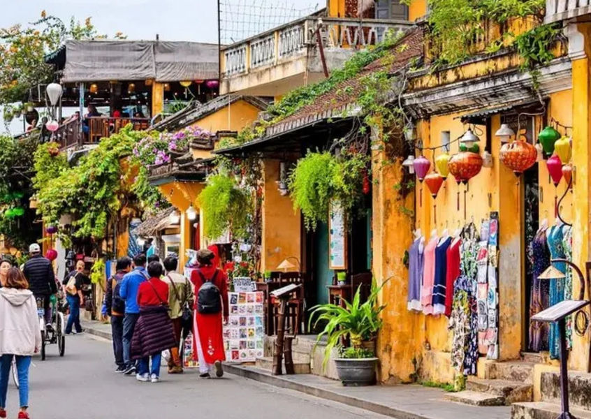 Hoi An ancient town street with yellow buildings and lanterns, Vietnam