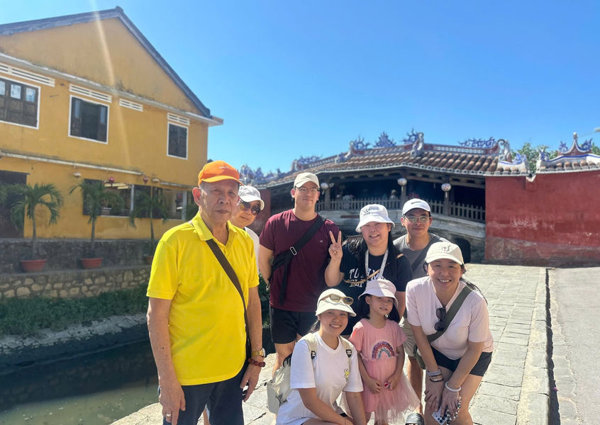 Small tour group walking through Hoi An Ancient Town streets