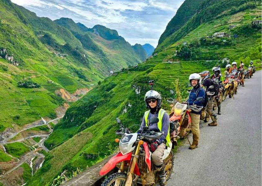 Motorbike tour group riding through Ha Giang mountains