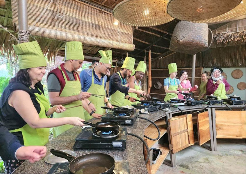 Students cooking at outdoor stove stations in Vietnam
