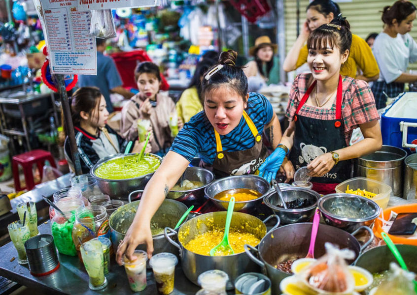 Street food vendor preparing dishes at a Vietnam night market