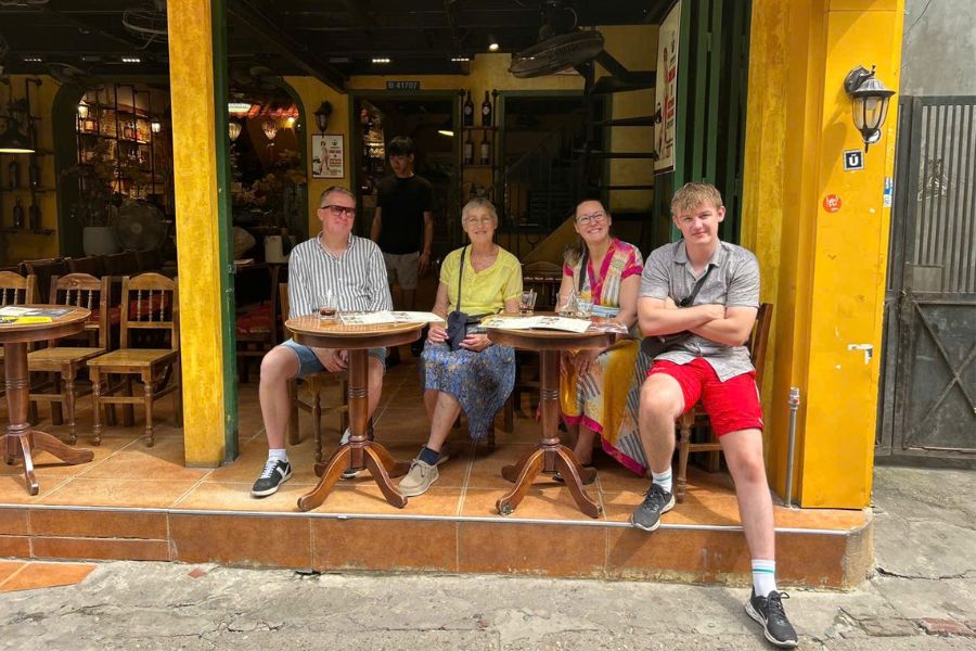 American travelers relaxing at a cafe in Hoi An, Vietnam