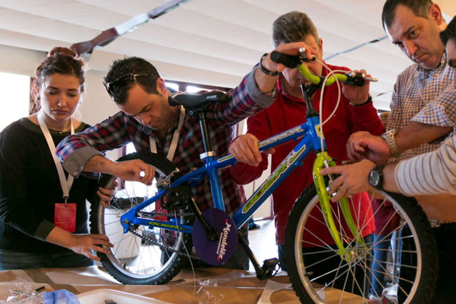 Colleagues assembling a bicycle together in a CSR team activity