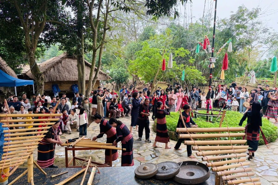 Performers playing bamboo instruments at an ethnic culture village